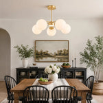 Load image into Gallery viewer, Gold five-light chandelier in a dining room
