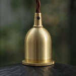 Load image into Gallery viewer, Brass tone holder detail on octagonal wood pendant light
