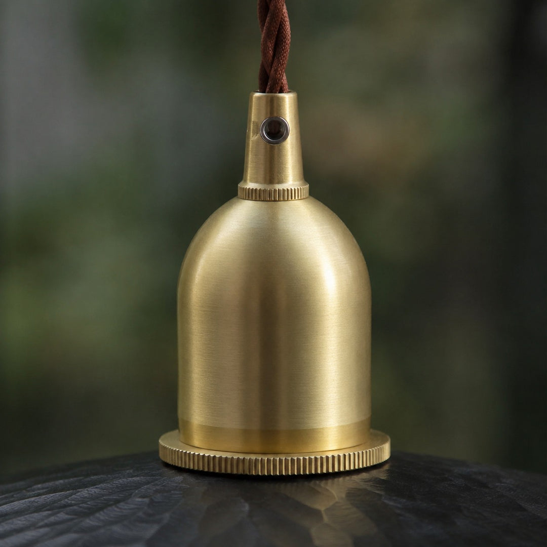 Brass tone holder detail on octagonal wood pendant light