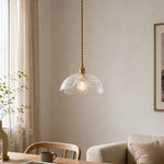 Cargar imagen en el visor de la Galería, Clear glass flower pendant above a light dining nook