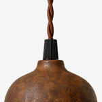 Charger l'image dans la visionneuse de galerie, Close-up of black cord holder and braided cord above rust shade