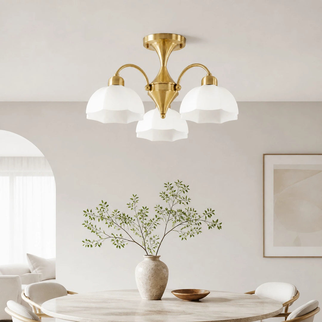 Three-light chandelier above a dining table in a bright interior