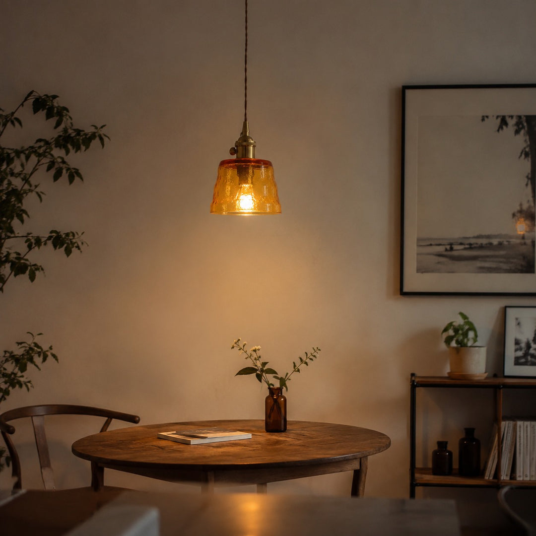 Amber glass pendant light above a dining table