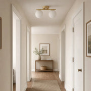 Gold milk glass ceiling light installed in a hallway