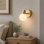 Load image into Gallery viewer, Single-light gold wall sconce in a warm interior