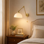 Load image into Gallery viewer, Gold swing arm wall lamp beside a bed