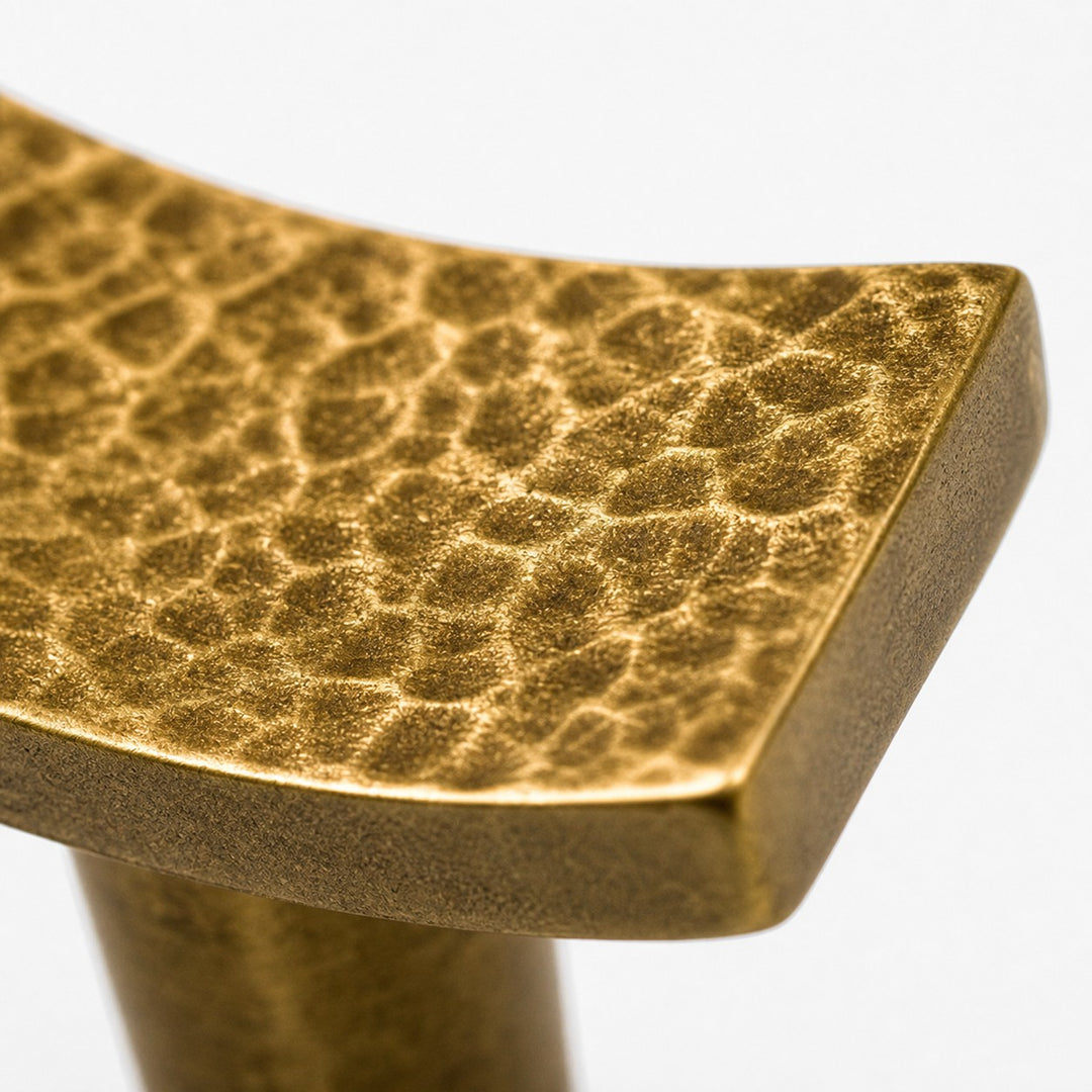 Rounded edge of hammered brass cabinet hardware