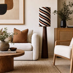 Bild in Gallery-Viewer laden, Striped floor lamp in a cozy reading corner with chair and art wall