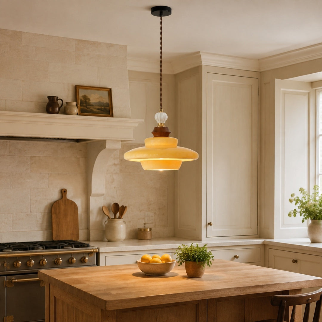 Caramel yellow glass pendant light over a kitchen island
