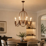 Load image into Gallery viewer, Antique bronze eight-light candle chandelier in a spacious dining room