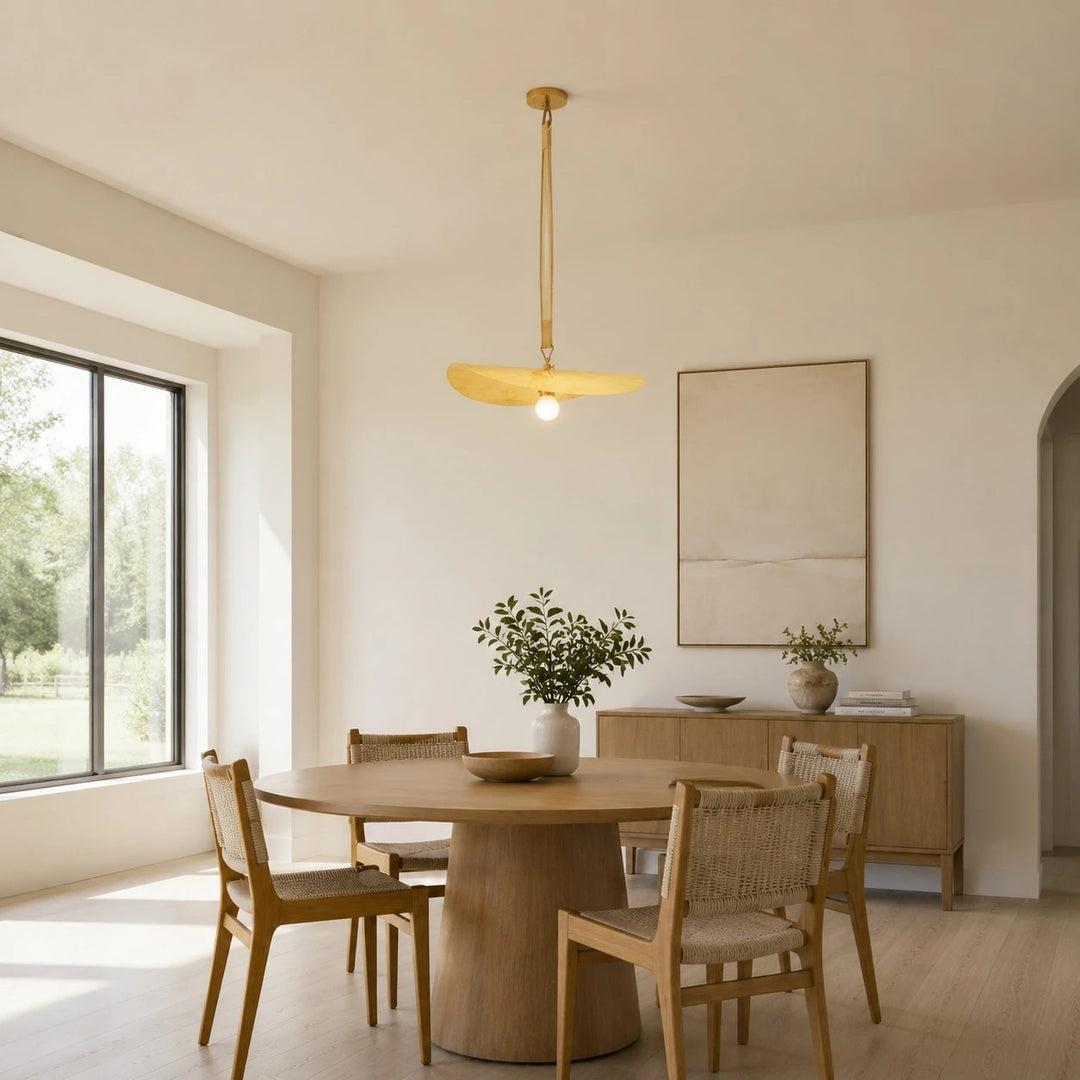 Pendant light installed above a round dining table