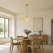 Pendant light installed above a round dining table