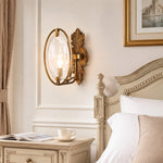 Load image into Gallery viewer, Antique brass textured glass wall sconce installed beside a bed