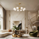 Charger l'image dans la visionneuse de galerie, Glass globe chandelier above a marble living area