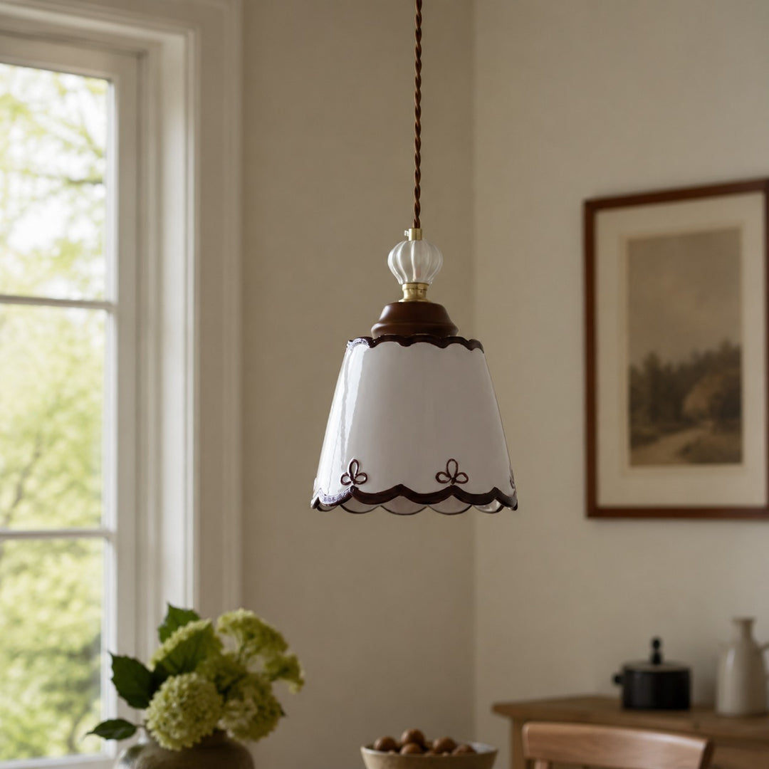 single ceramic pendant light in a warm dining corner