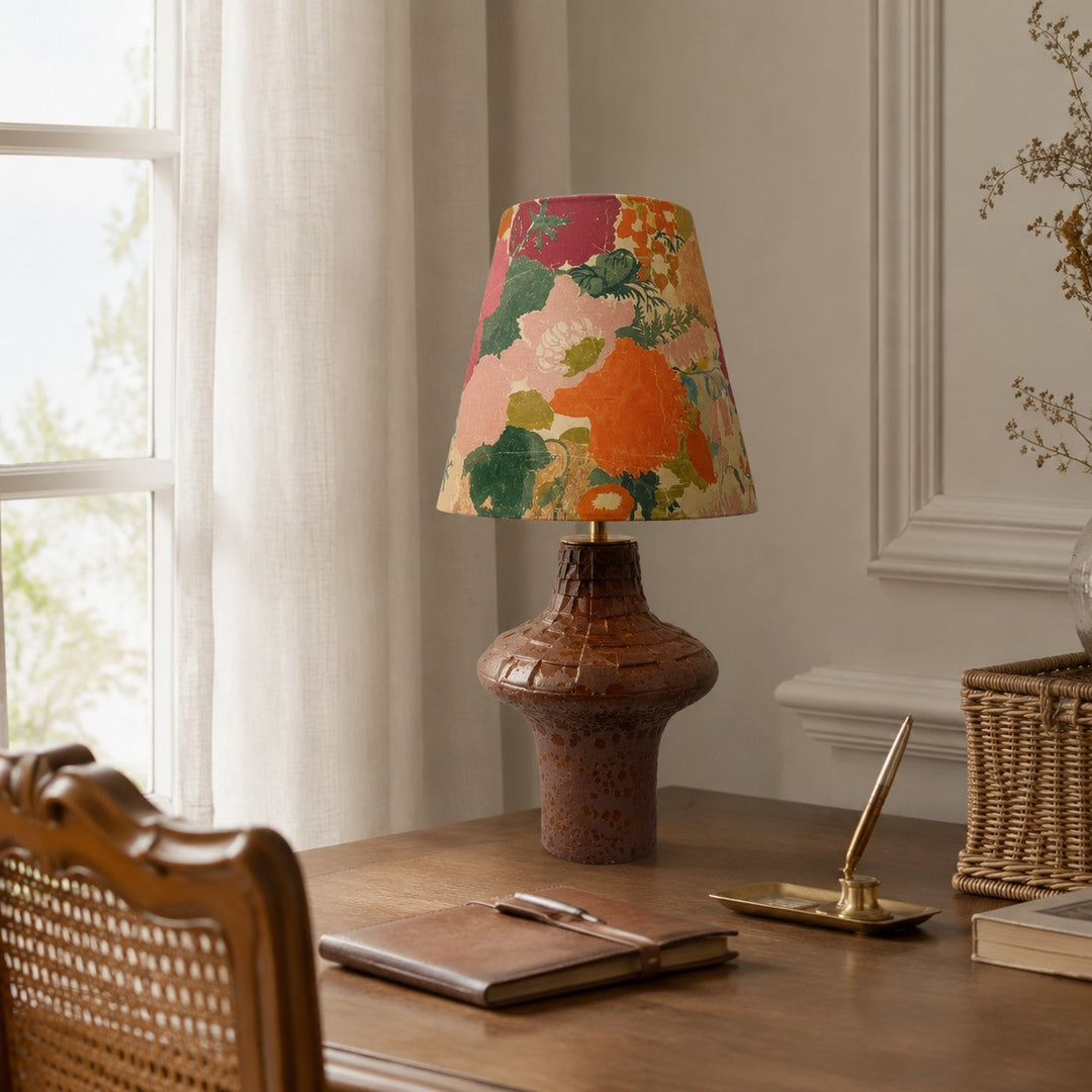 Orange floral ceramic table lamp on a writing desk