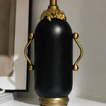 Load image into Gallery viewer, Close-up of matte black table lamp with antique brass-toned handles