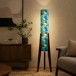 Load image into Gallery viewer, Multicolor striped tripod floor lamp in a warm room setting