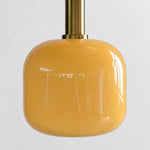 Bild in Gallery-Viewer laden, Close view of the rounded glossy yellow glass shade and brass holder