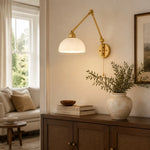 Load image into Gallery viewer, Milk glass swing arm wall lamp in a living room