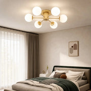Gold globe ceiling light in a calm modern bedroom