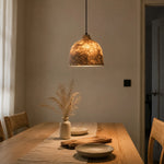 Bild in Gallery-Viewer laden, Handmade paper pendant light glowing above a dining table