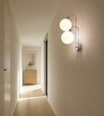 Charger l'image dans la visionneuse de galerie, Milk coffee globe wall lamp mounted beside a bedroom nightstand