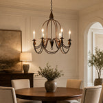 Load image into Gallery viewer, Antique bronze six-light candle chandelier in a paneled dining room