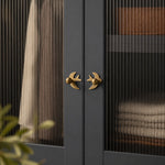 Cargar imagen en el visor de la Galería, Mirrored antique brass swallow handles on a dark cabinet