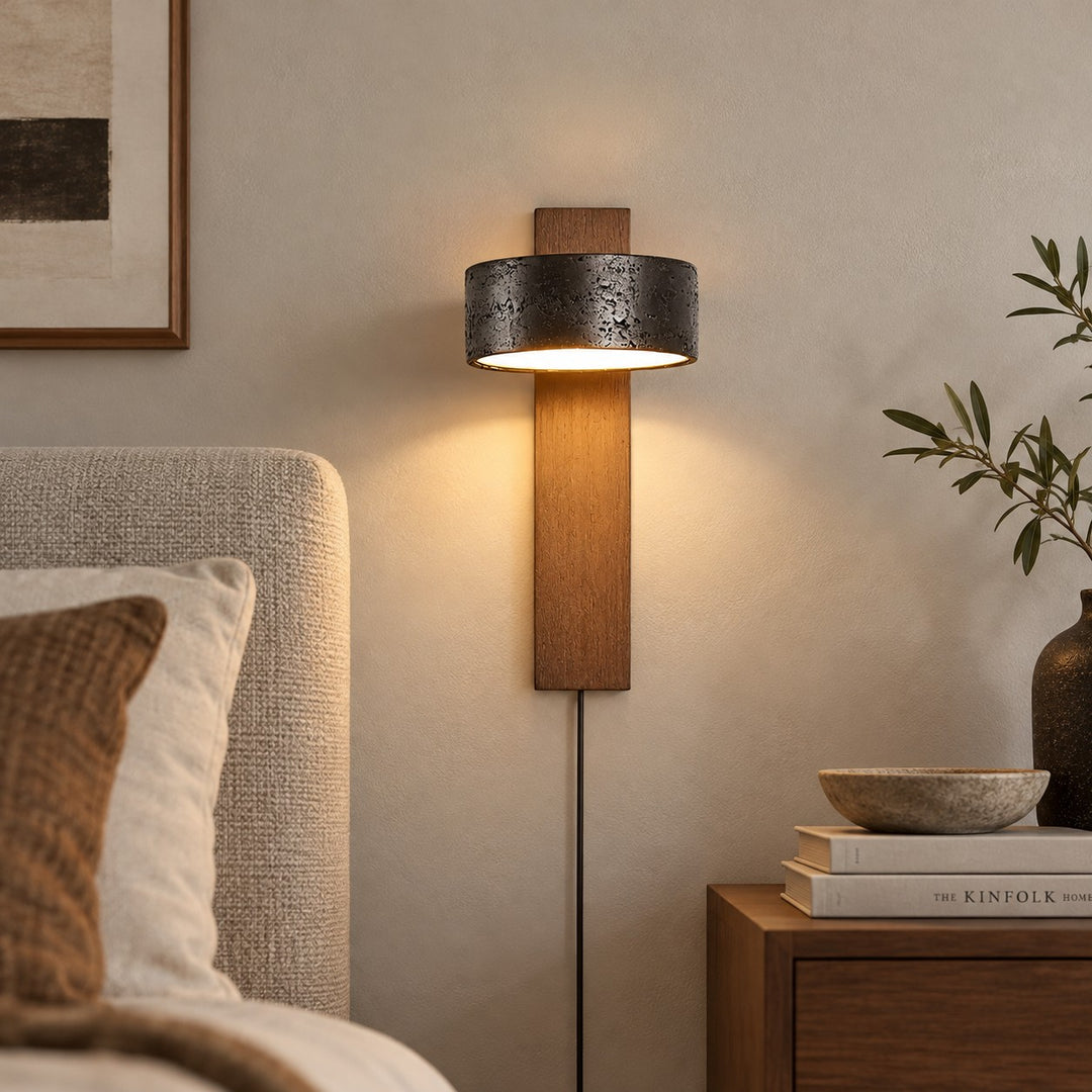Walnut and black travertine wall sconce in a daylight hallway