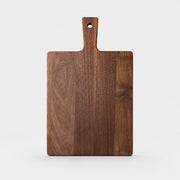Large black walnut cutting board on a light background