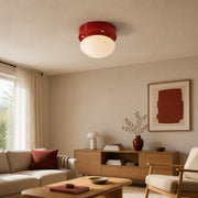 Red glass LED ceiling light in a warm modern living room