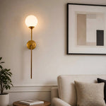Cargar imagen en el visor de la Galería, Gold wall sconce in a contemporary living room