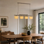 Load image into Gallery viewer, Cream layered glass chandelier above a wood dining table