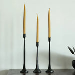 Cargar imagen en el visor de la Galería, Three-piece black iron candle holder set styled with customer-supplied taper candles; candles not included