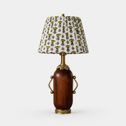 Deep brown vintage table lamp with yellow floral pleated shade on white background