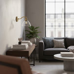 Load image into Gallery viewer, Driscoll Minimalist Clear Glass &amp; Brass Wall Sconce – Adjustable Modern Wall Light for Bedroom or Hallway
