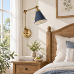 Load image into Gallery viewer, Blue cone shade on a gold swing arm beside a bed