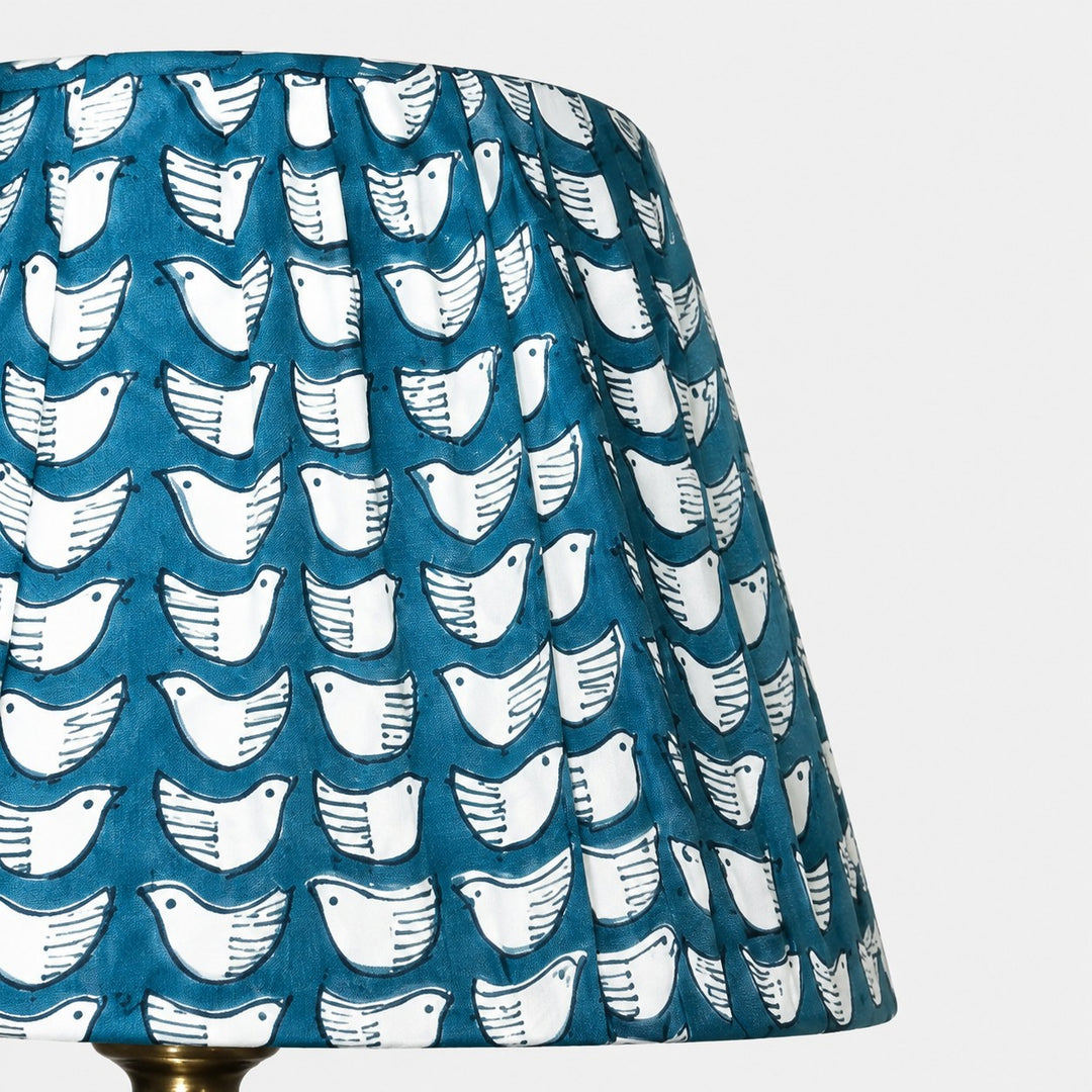Teal pleated fabric shade with white bird pattern detail