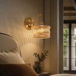 Cargar imagen en el visor de la Galería, Amber ripple glass wall light casting warm bedside texture