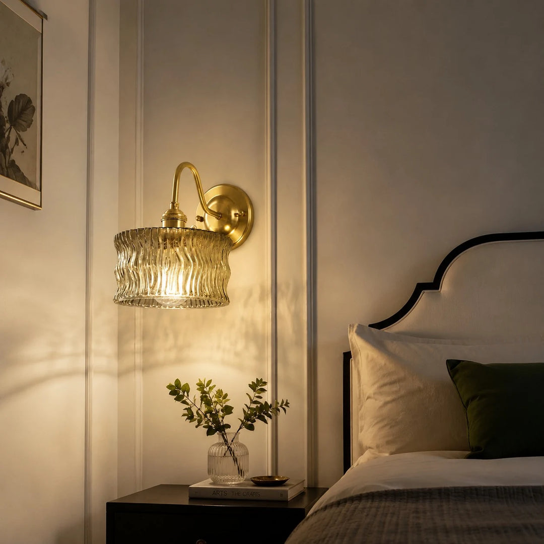 Vintage ripple glass wall light installed beside a bed