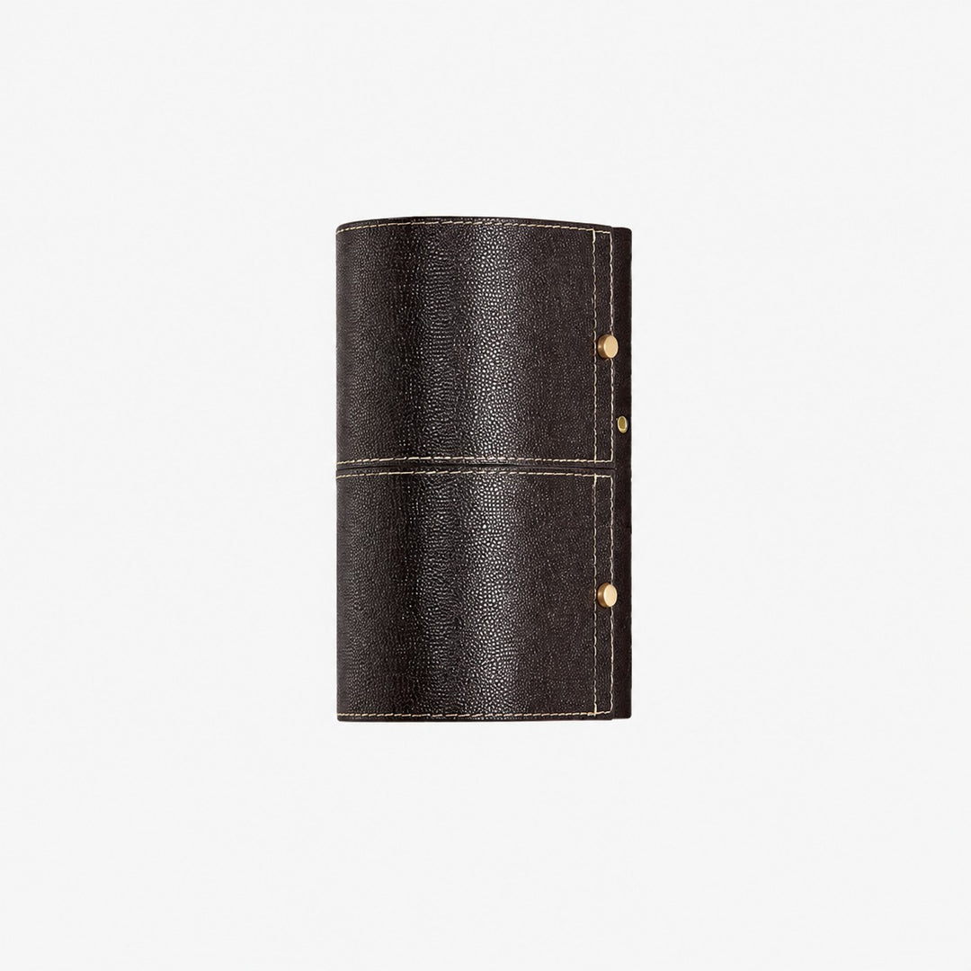 Dark brown leather wrapped wall sconce on clean background