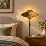 Charger l'image dans la visionneuse de galerie, Gold moth wall sconce beside a bed in daylight