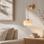 Load image into Gallery viewer, Scalloped shade wall sconce installed in a living room