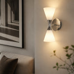 Cargar imagen en el visor de la Galería, White and chrome Bauhaus wall sconce glowing on a hallway wall