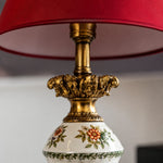 Load image into Gallery viewer, Antique metal detail below the red lampshade