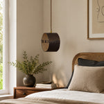 Bild in Gallery-Viewer laden, Hand-laced leather cylinder pendant light in an interior setting