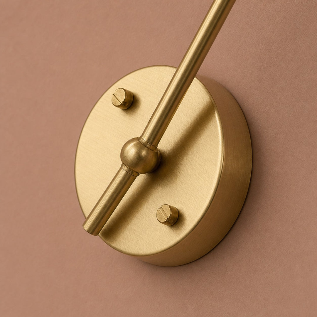 Round brass wall backplate detail on glass wall light