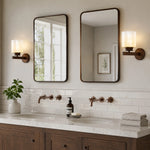 Cargar imagen en el visor de la Galería, Pair of aged bronze sconces above a double bathroom vanity