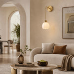 Load image into Gallery viewer, Petal shade wall sconce installed beside a living room sofa